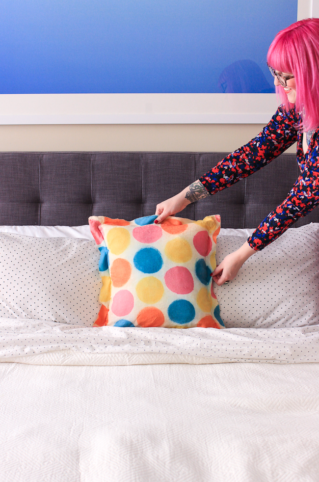 Add some color to your bed with these diy painted polka dot pillows!
