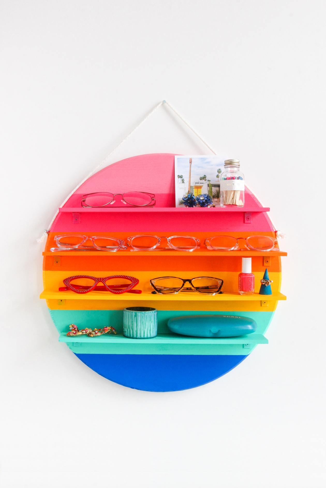 Add color to your storage with this DIY Rainbow Circle Shelf! Great for sunglass storage, nail polish storage, and displaying other small items. This DIY Circle Shelf is the perfect beginner project to get started using power tools.